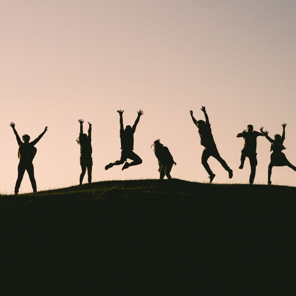 Fundraisers celebrate against a sunset backdrop
