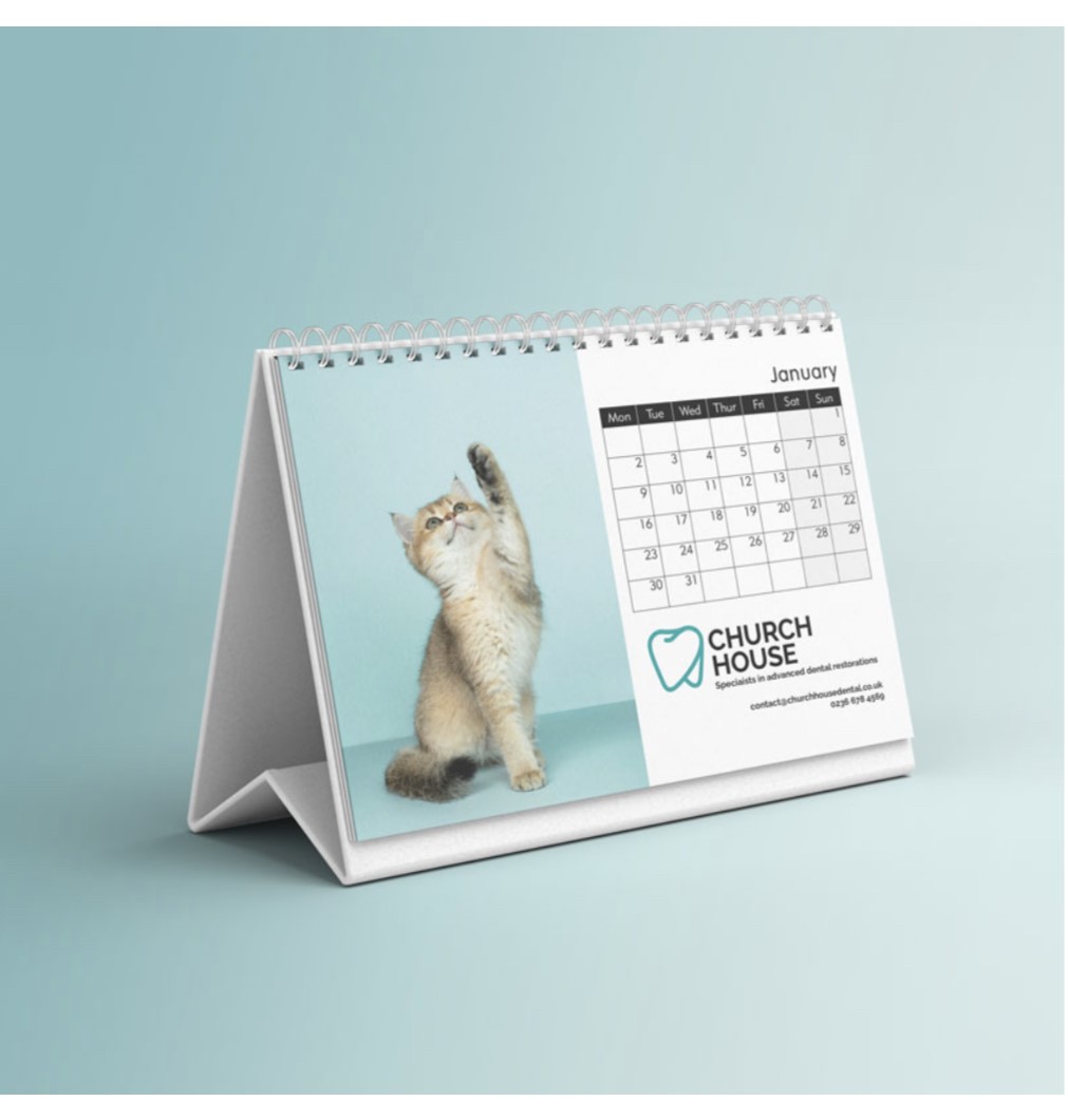 A desk calendar featuring photo of cute kitten